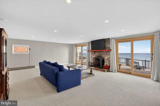 a living room with furniture tv and a fireplace