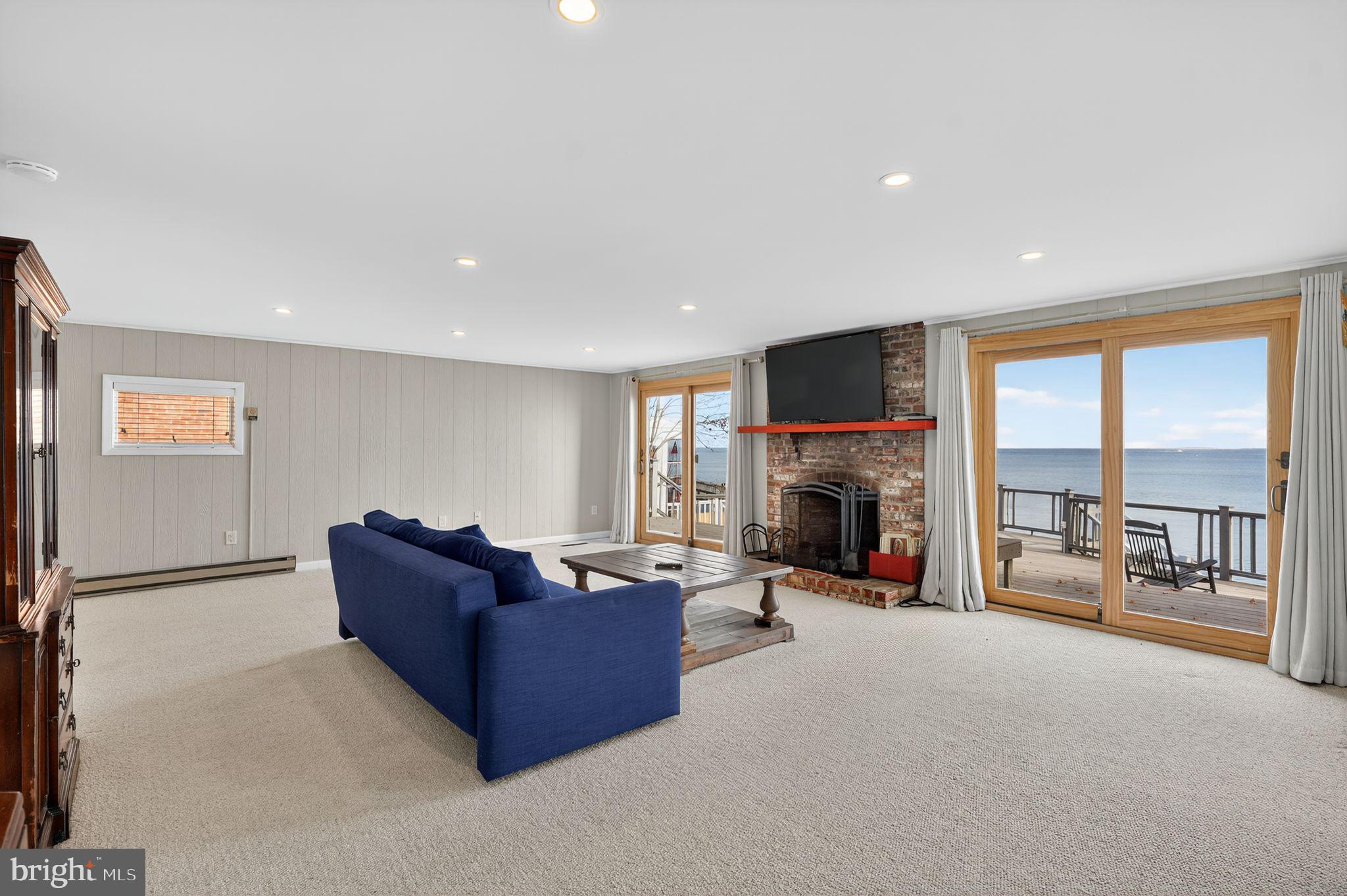 7523 B Street Chesapeake Beach, MD 20732 - Photo 19 of 29 a living room with furniture tv and a fireplace