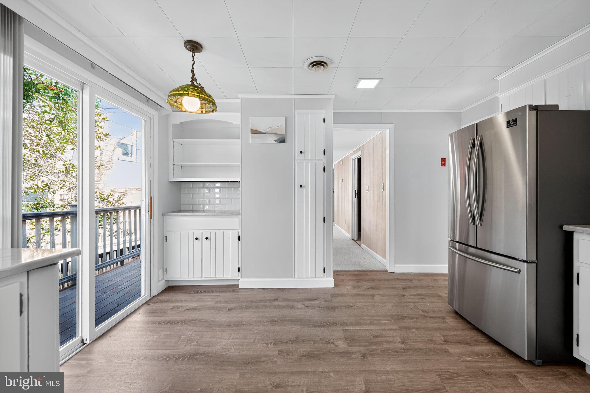 7523 B Street Chesapeake Beach, MD 20732 - Photo 7 of 29 a view of a kitchen with a refrigerator and windows