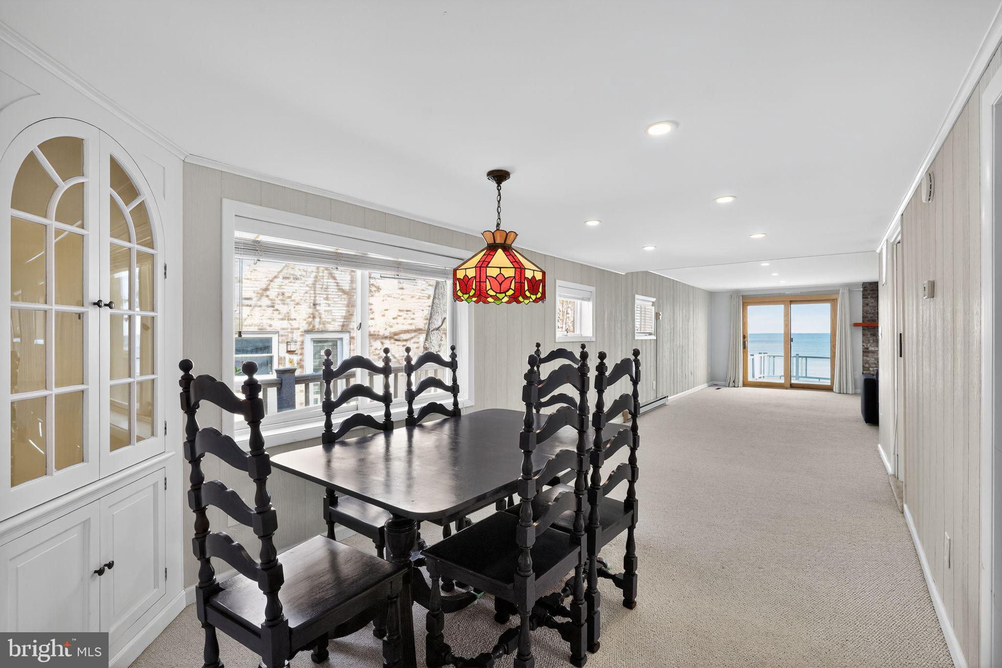 7523 B Street Chesapeake Beach, MD 20732 - Photo 8 of 29 a dining room with furniture a chandelier and wooden floor