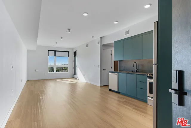 a kitchen with sink and refrigerator