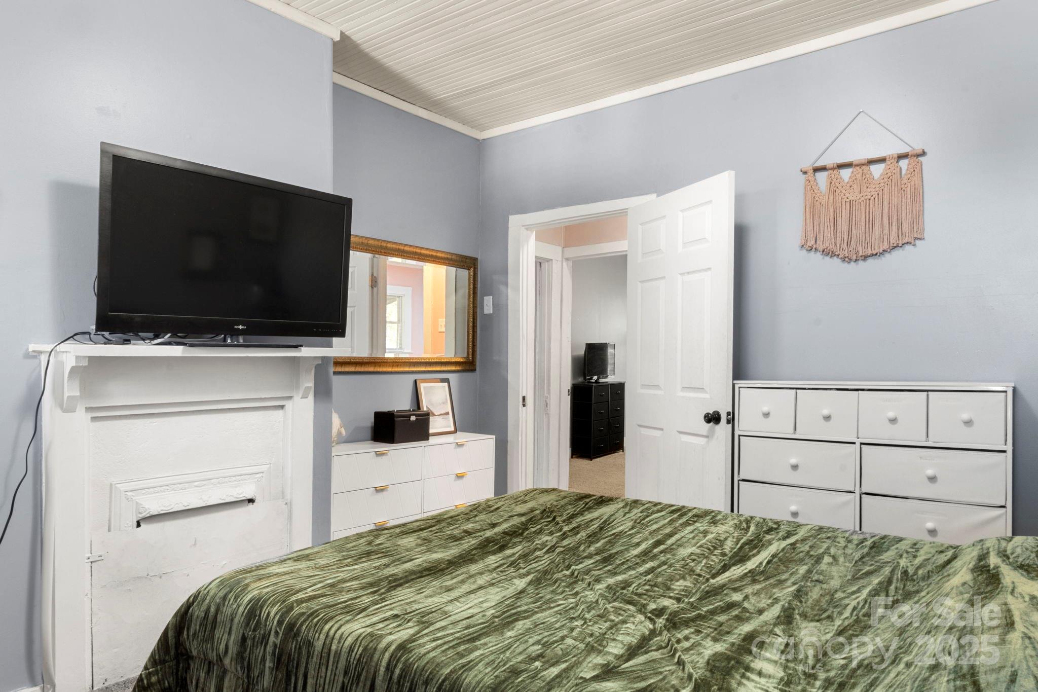 204 Shelby Street Hickory, NC 28601 - Photo 15 of 22 a bedroom with a bed and a flat screen tv