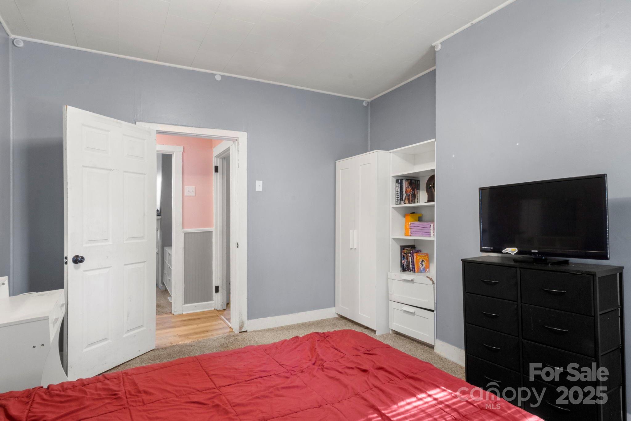 204 Shelby Street Hickory, NC 28601 - Photo 17 of 22 a bedroom with a bed and a flat screen tv