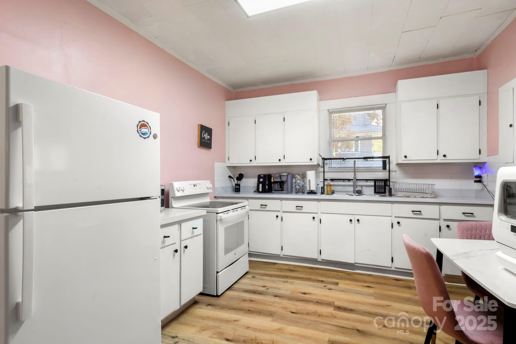 204 Shelby Street Hickory, NC 28601 - Photo 21 of 22 a kitchen with a sink appliances and cabinets