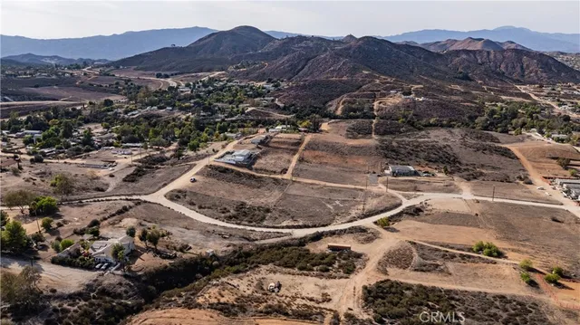 a view of a house with a mountain and a forest