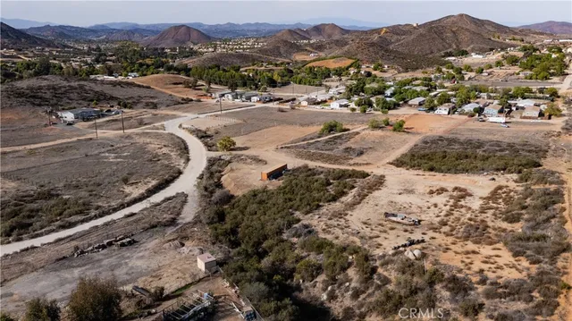 a view of a dry yard with wooden fence