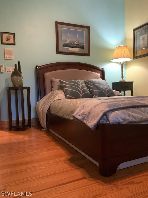 7231 Pineland Road Bokeelia, FL 33922 - Photo 12 of 24 a bedroom with a bed and painting on the wall