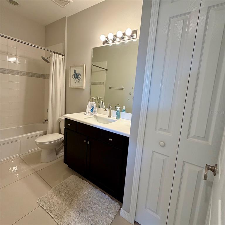 3105 Trustee Avenue Sarasota, FL 34243 - Photo 12 of 14 a spacious bathroom with a double vanity sink toilet and a mirror