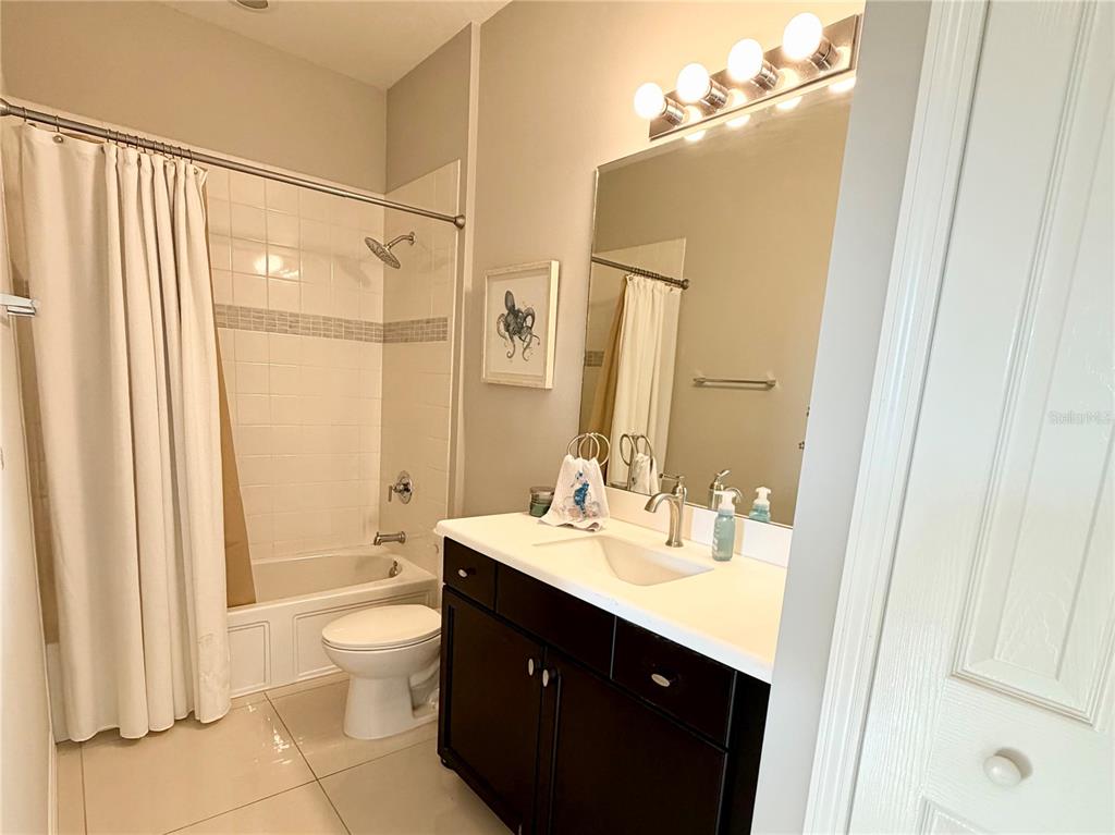 3105 Trustee Avenue Sarasota, FL 34243 - Photo 16 of 19 a bathroom with a sink vanity mirror and toilet