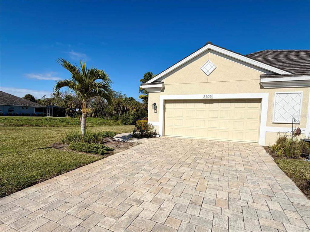 3105 Trustee Avenue Sarasota, FL 34243 - Photo 2 of 19 a front view of a house with a yard