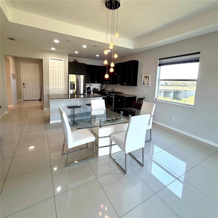 3105 Trustee Avenue Sarasota, FL 34243 - Photo 5 of 14 a view of a dining room with furniture wooden floor and chandelier