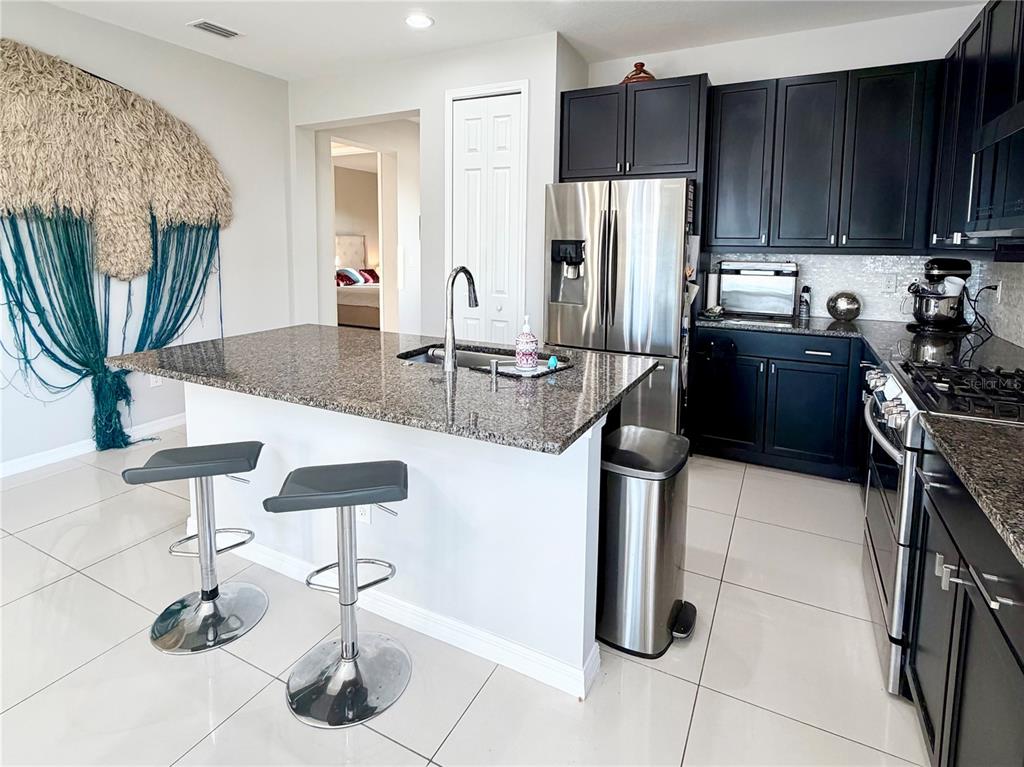 3105 Trustee Avenue Sarasota, FL 34243 - Photo 5 of 19 a kitchen with stainless steel appliances granite countertop a refrigerator a stove and a sink