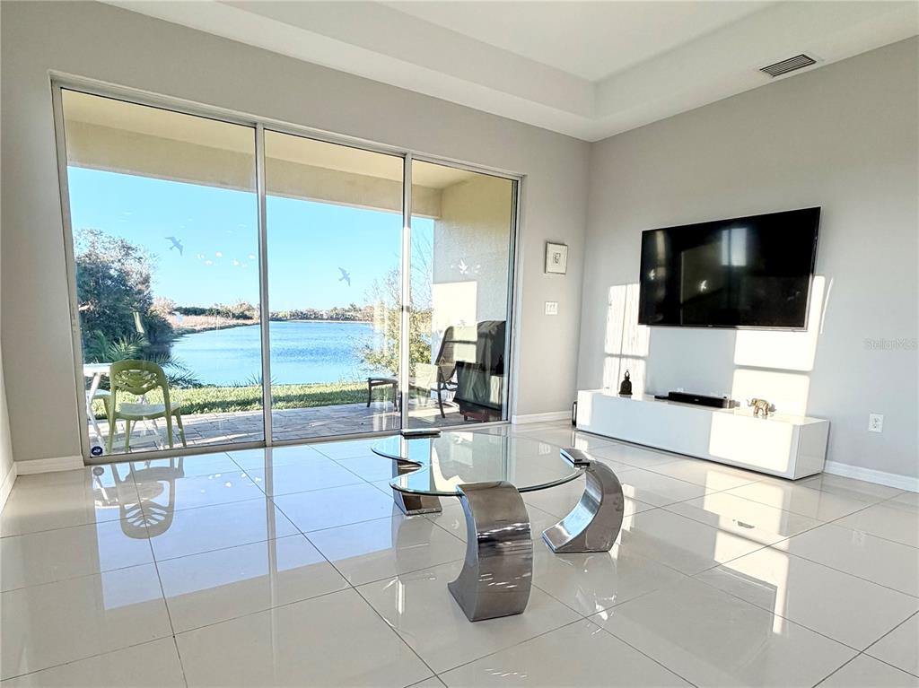 3105 Trustee Avenue Sarasota, FL 34243 - Photo 9 of 19 a living room with patio furniture and a flat screen tv
