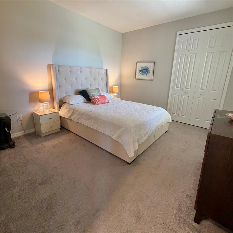 3105 Trustee Avenue Sarasota, FL 34243 - Photo 10 of 14 a large bed sitting in a bedroom next to a window