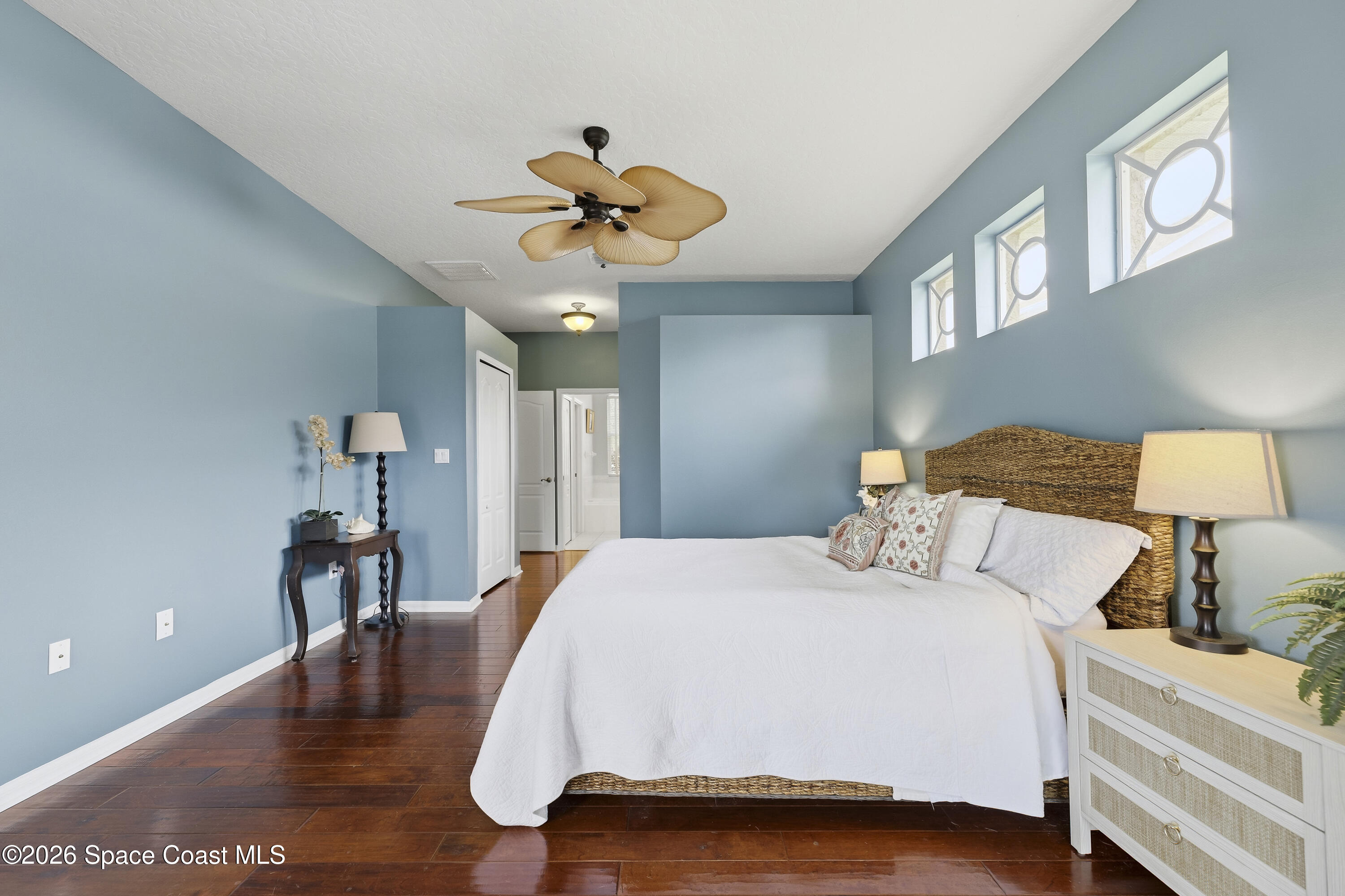 1643 Long Pine Road Melbourne, FL 32940 - Photo 29 of 63 a bedroom with a bed and a chandelier