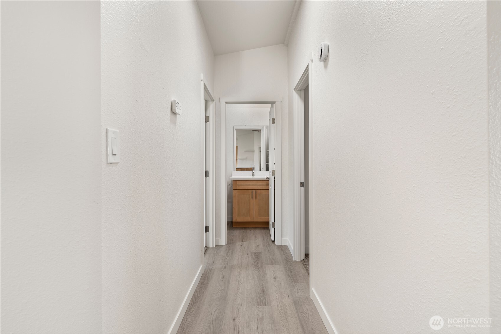 10324 Delphi Road Southwest, Unit 17 Olympia, WA 98512 - Photo 10 of 24 a view of a hallway with wooden floor and a bathroom