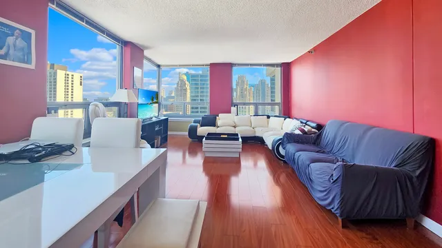 a living room with furniture and large windows