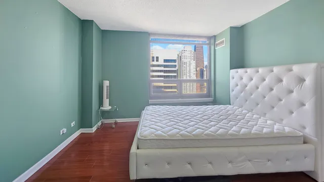 a bedroom with a bed and a window