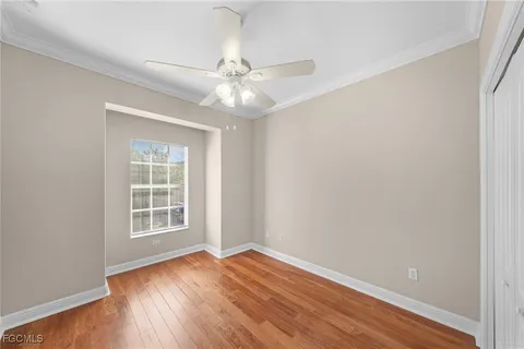 an empty room with a window and wooden floor