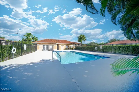 a view of pool with lawn chairs and couches