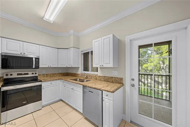 a kitchen with stainless steel appliances granite countertop a refrigerator stove microwave and sink