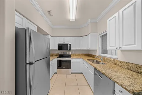 a white refrigerator freezer and a stove in a kitchen