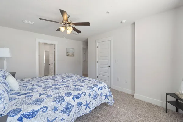 a bedroom with a bed and a chandelier