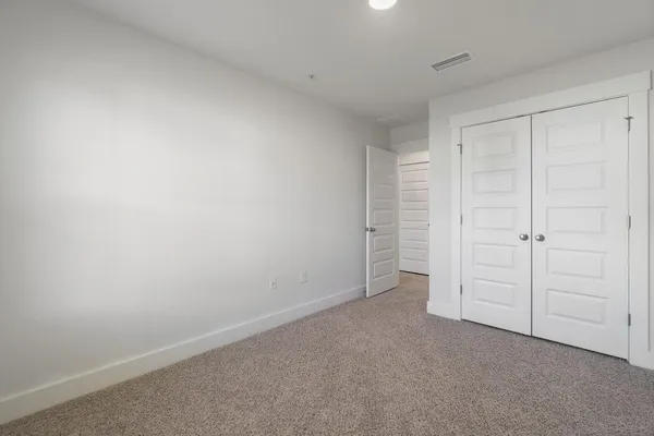 a view of an empty room and closet