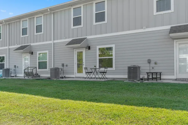 a view of a house with a yard and sitting area