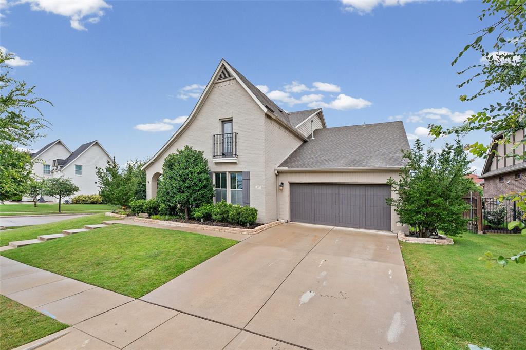 437 Prairie Run Aledo, TX 76008 - Photo 1 of 33 Gabled stucco exterior with a prominent second-story Juliet balcony, a two-car garage, and a concrete driveway