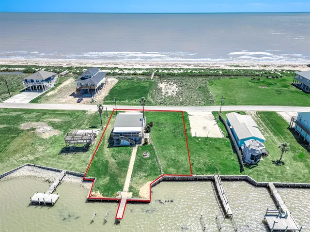 a view of a swimming pool with an outdoor seating and a yard