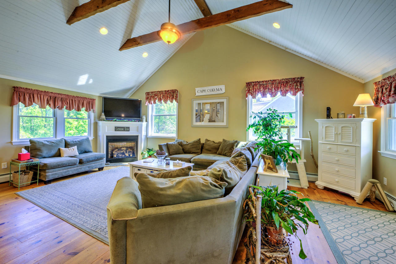 22 Chase Road Edgartown, MA 02539 - Photo 11 of 35 a living room with furniture a fireplace and a flat screen tv