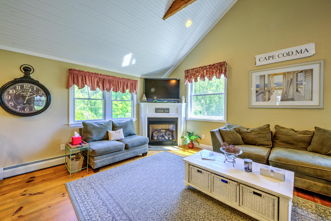 22 Chase Road Edgartown, MA 02539 - Photo 14 of 35 a living room with furniture a rug and a fireplace