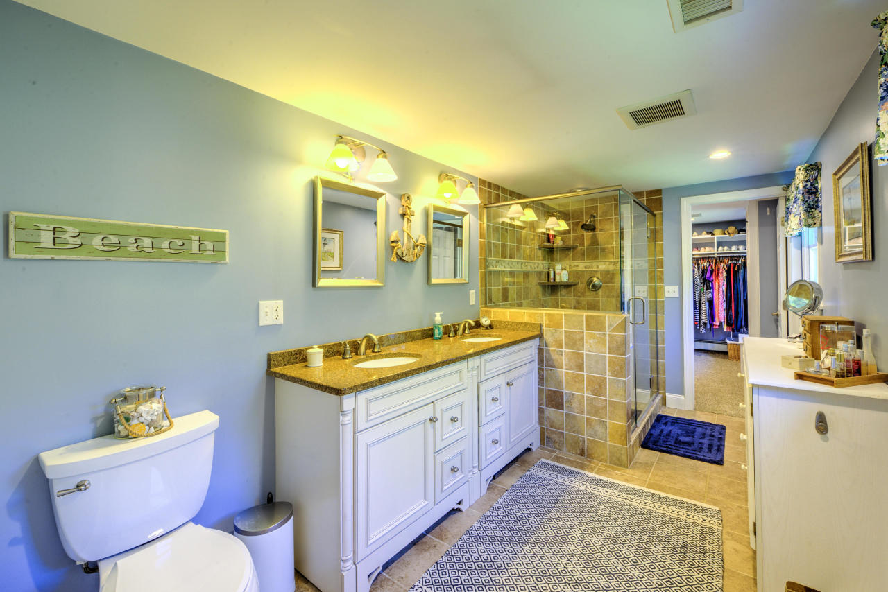 22 Chase Road Edgartown, MA 02539 - Photo 26 of 35 a bathroom with a sink mirror vanity and toilet