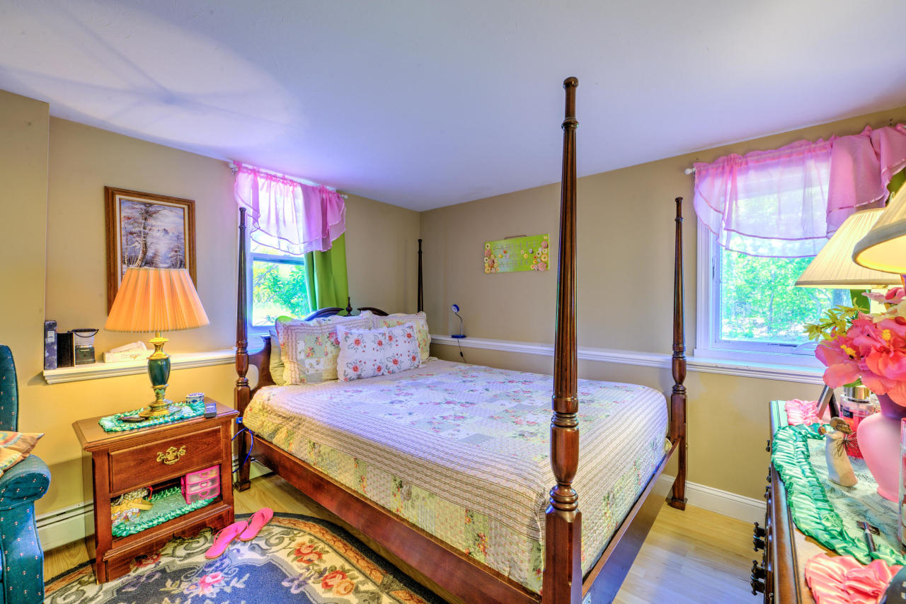 22 Chase Road Edgartown, MA 02539 - Photo 30 of 35 a bedroom with a bed a dresser next to a window