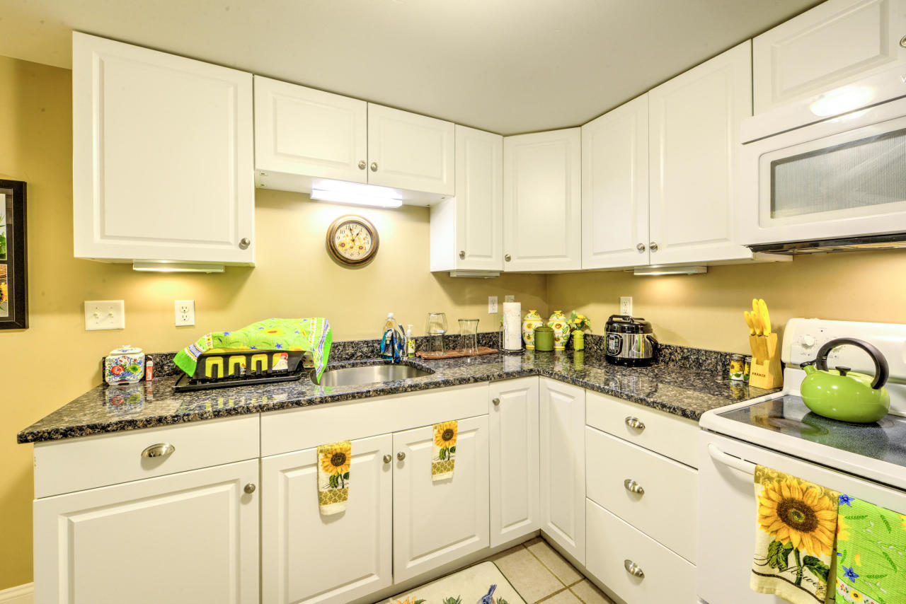 22 Chase Road Edgartown, MA 02539 - Photo 32 of 35 a kitchen with granite countertop a sink a stove and cabinets