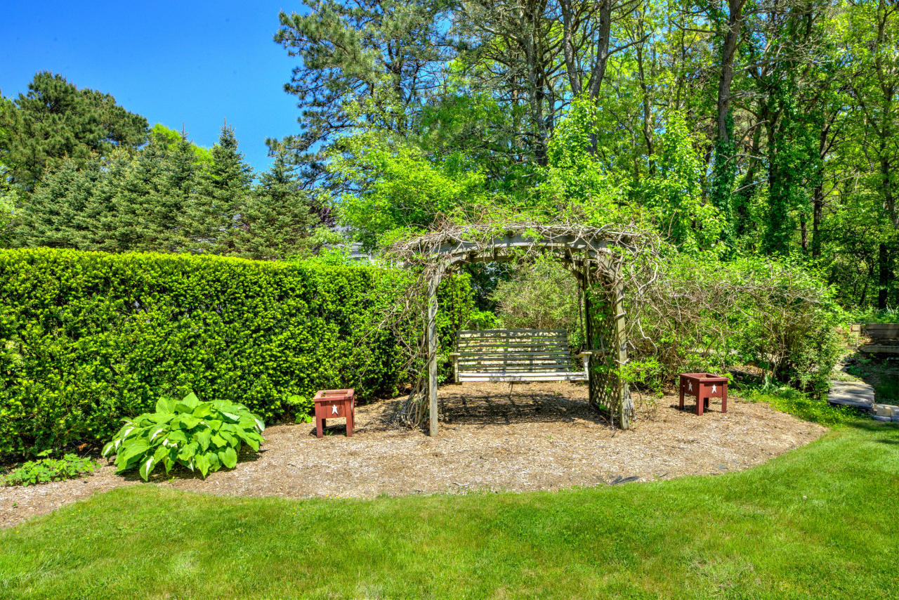22 Chase Road Edgartown, MA 02539 - Photo 5 of 35 a view of a bench in the garden