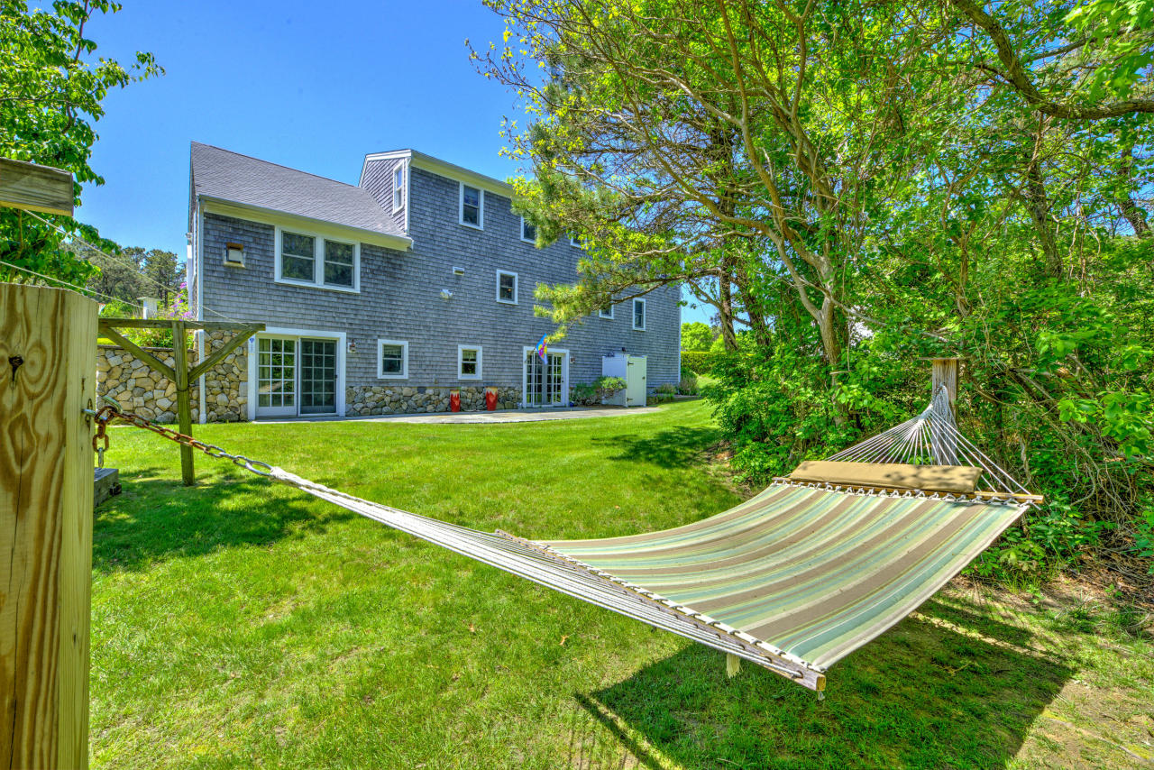 22 Chase Road Edgartown, MA 02539 - Photo 6 of 35 a view of a white house in a big yard with large trees