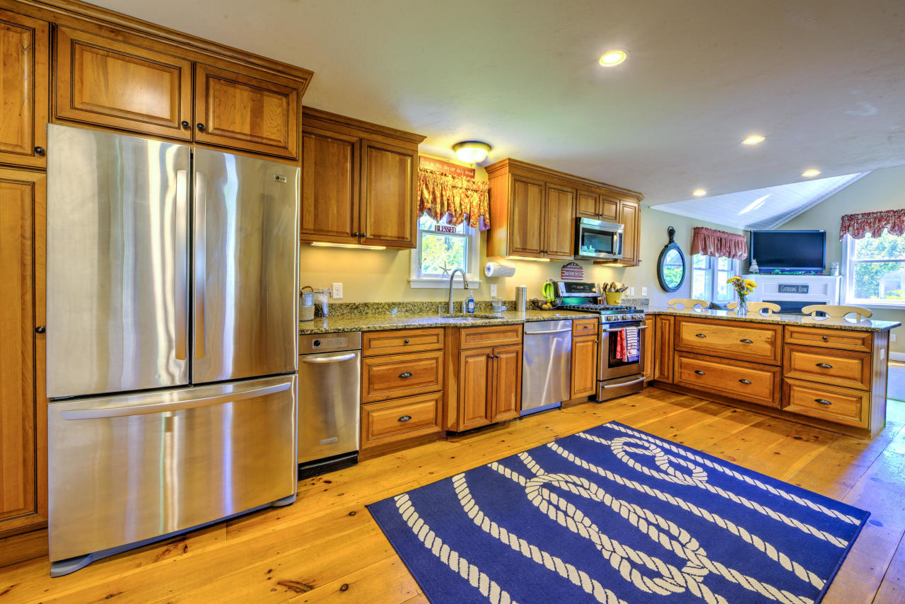 22 Chase Road Edgartown, MA 02539 - Photo 9 of 35 a kitchen with stainless steel appliances granite countertop a refrigerator sink and cabinets