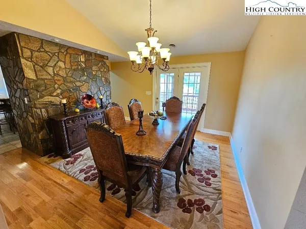 a view of a dining room with furniture and a chandelier