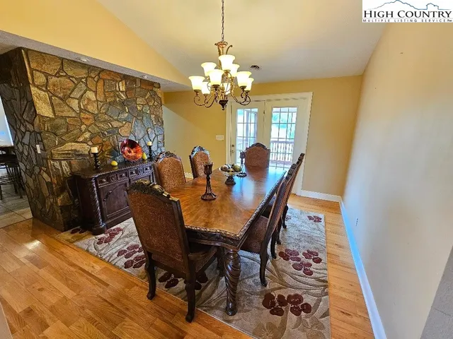 a view of a dining room with furniture and a chandelier