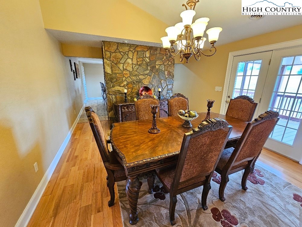 611 Barrett Road Ennice, NC 28623 - Photo 18 of 45 a view of a dining room with furniture and a chandelier