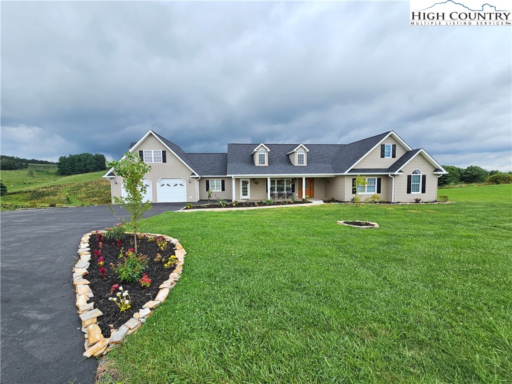 611 Barrett Road Ennice, NC 28623 - Photo 2 of 45 a front view of a house with garden