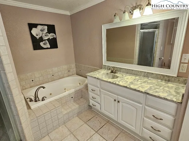 a bathroom with a bathtub sink and mirror