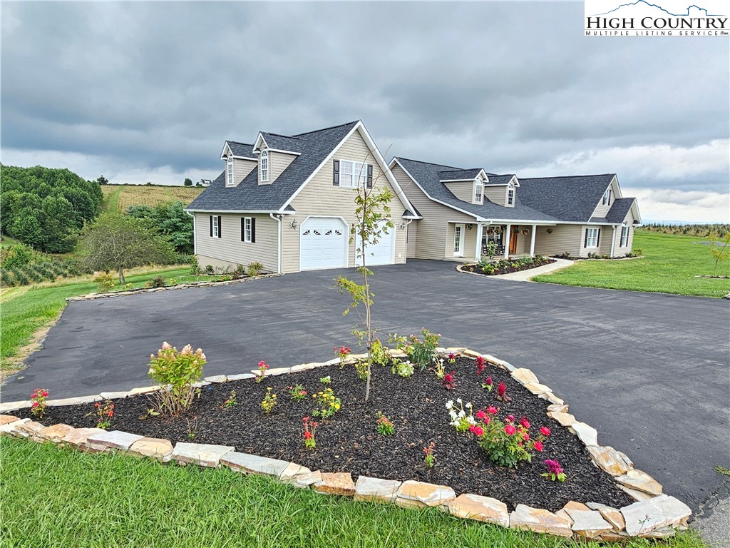611 Barrett Road Ennice, NC 28623 - Photo 4 of 45 a front view of a house with a yard and a garden