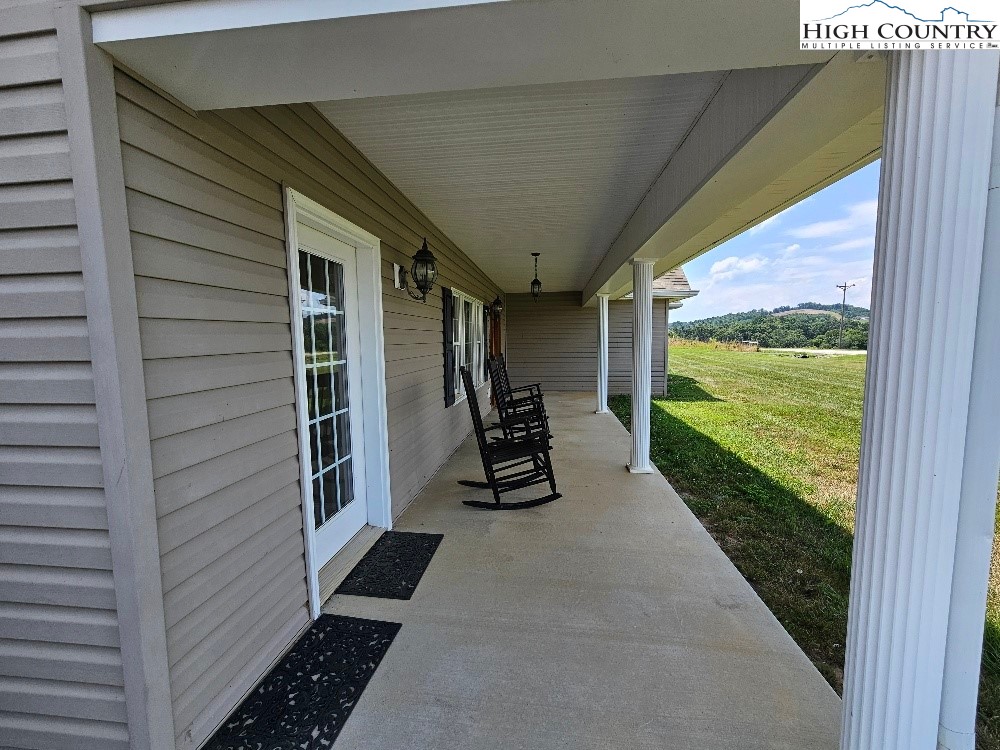 611 Barrett Road Ennice, NC 28623 - Photo 42 of 45 a view of a porch with wooden floor and stairs