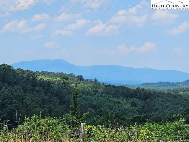 a view of a town with mountains in the background