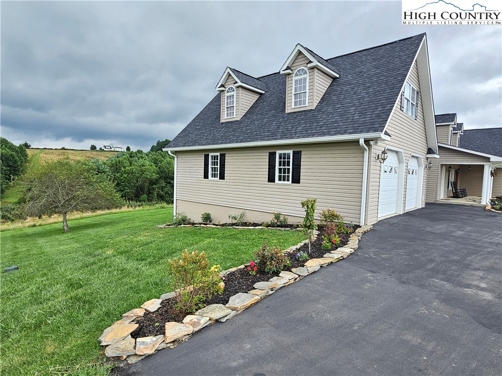 611 Barrett Road Ennice, NC 28623 - Photo 5 of 45 a front view of a house with a yard and garage