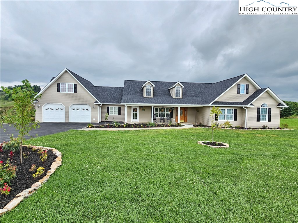 611 Barrett Road Ennice, NC 28623 - Photo 7 of 45 a front view of a house with a garden