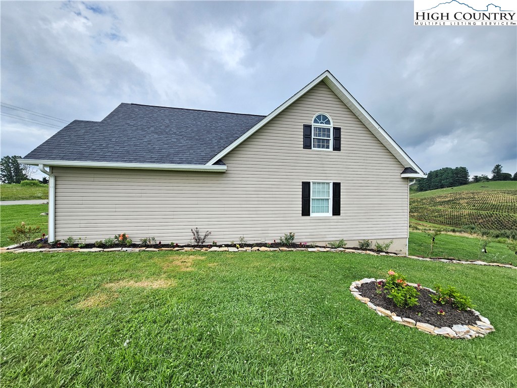 611 Barrett Road Ennice, NC 28623 - Photo 8 of 45 a front view of a house with a yard